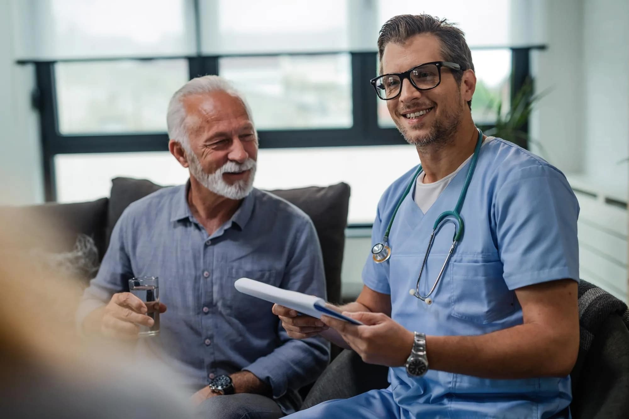 Doctor sitting with satisfied patient