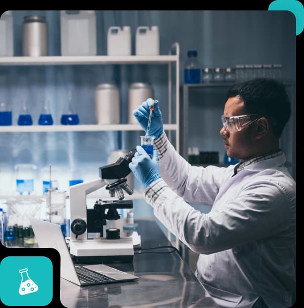 A laboratory scientist in a white coat and safety glasses pipetting a blue sample into a beaker beside a microscope and a laptop, in a rounded frame with a teal flask mark at its lower left