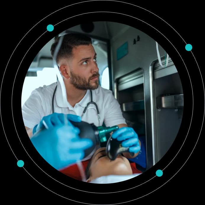 Paramedic treating a patient inside an ambulance