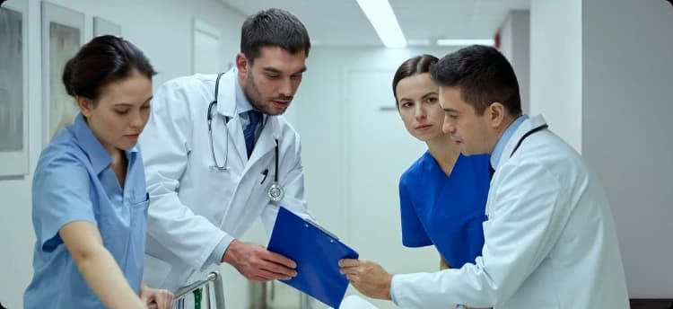 EMS clinicians reviewing patient documentation in a hospital corridor