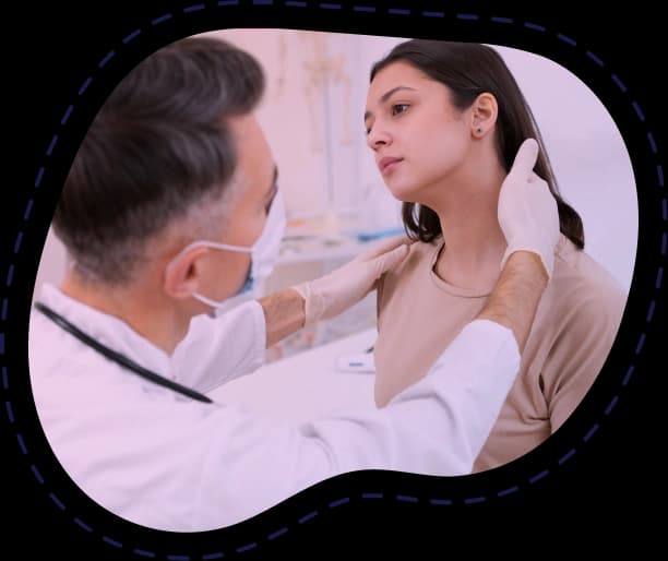 Endocrinologist examining a patient's thyroid during a clinic consultation