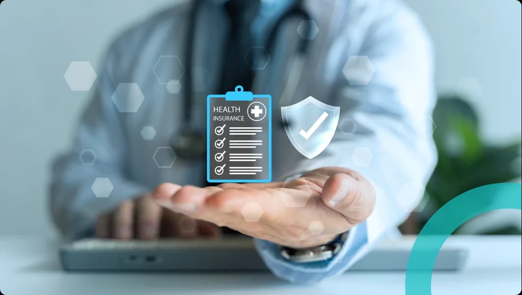 Clinician at a laptop holding out a health insurance checklist and a verified shield
