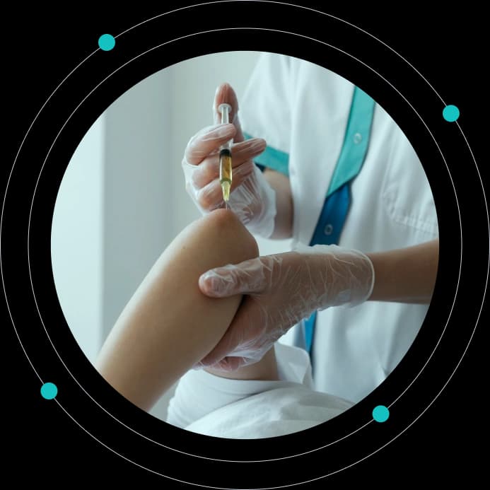 Clinician administering an injection into a patient's vein