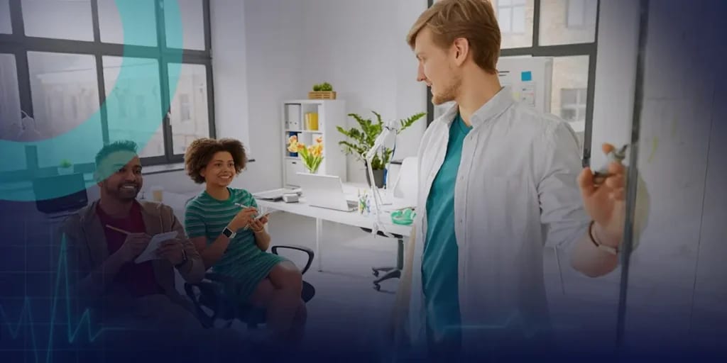 Behavioral health clinicians reviewing notes while a colleague works at a whiteboard