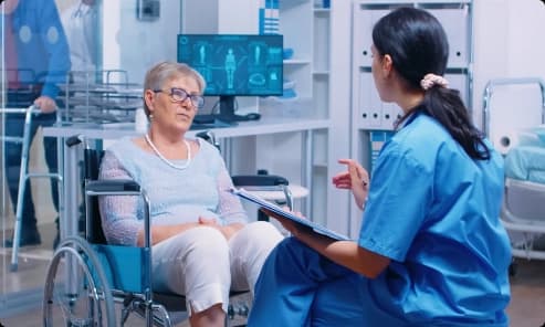 Nurse consulting with a patient in a hospital wheelchair