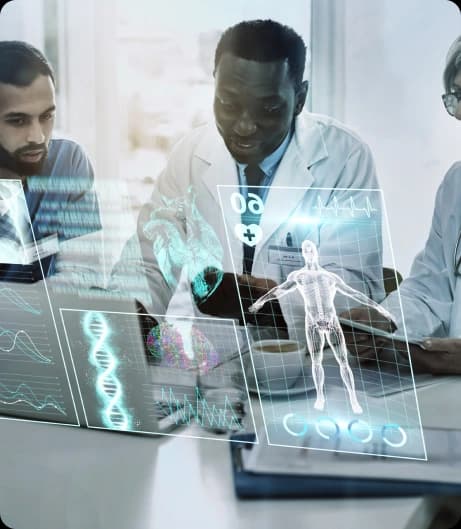 Three clinicians at a desk reviewing patient data through a translucent screen of charts, waveforms and an anatomical scan
