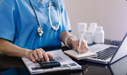 Certified coder reviewing ICD-10 and CPT codes