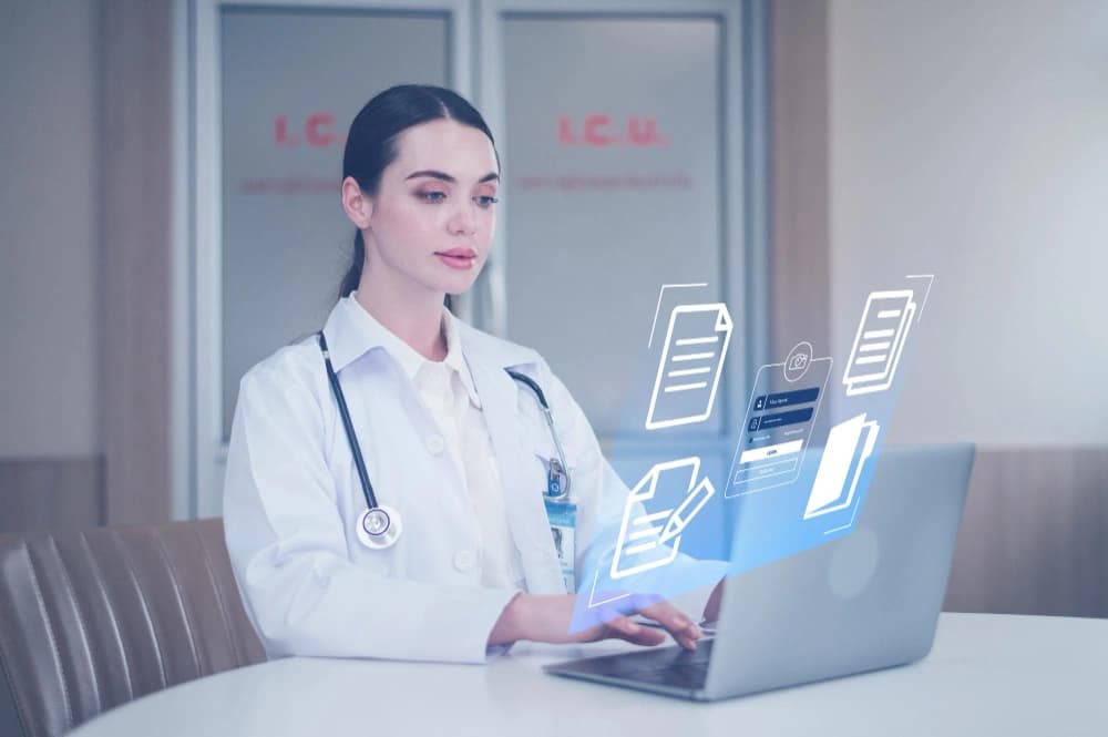 Clinician reviewing patient records in an EHR system on a laptop